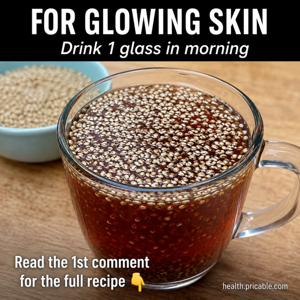 A refreshing glass of a yellow-orange morning glow drink garnished with a slice of lemon and a small piece of ginger aga