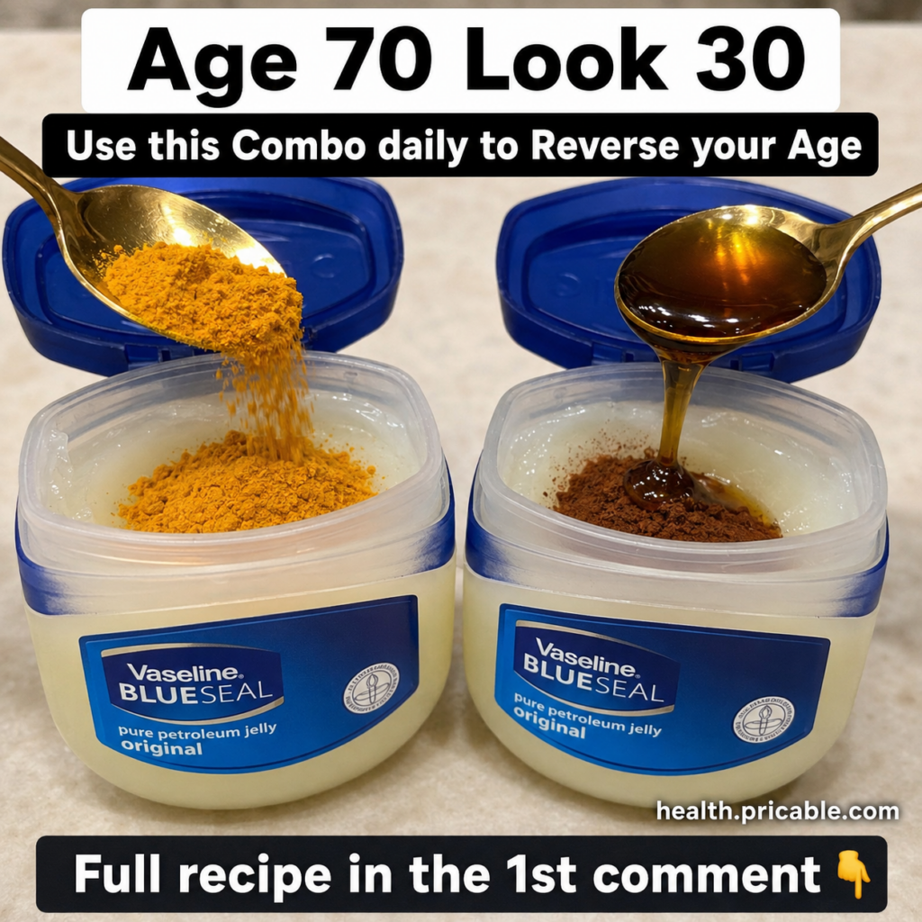 A small glass jar with a creamy yellowish-orange face mask made of Vaseline turmeric and honey with a small spoon beside