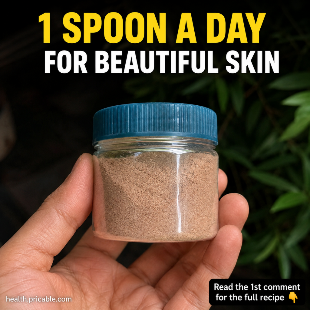 A close-up of a wooden spoon holding a finely ground light beige beauty powder with natural ingredients like berries see