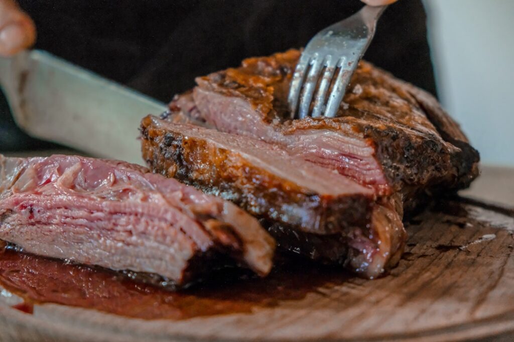 A perfectly cooked steak sliced to show different levels of doneness rare medium-rare medium and well-done with clear vi