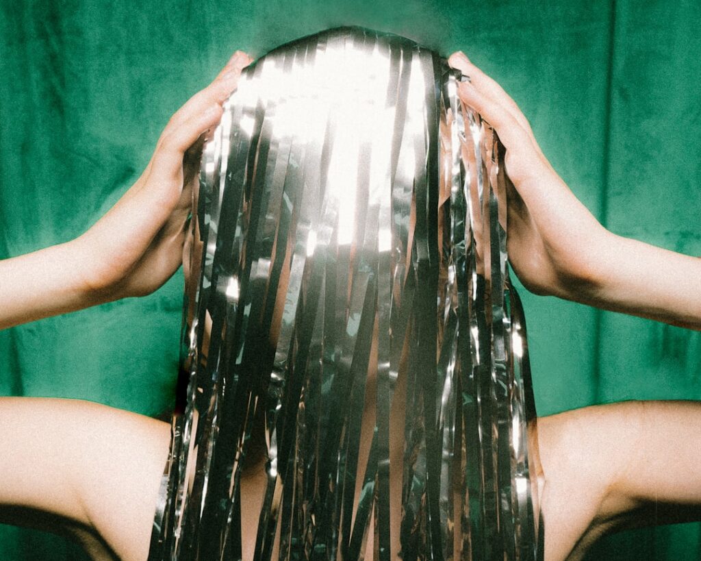 Woman washing her hair after a treatment showing water rinsing through her dark shiny hair