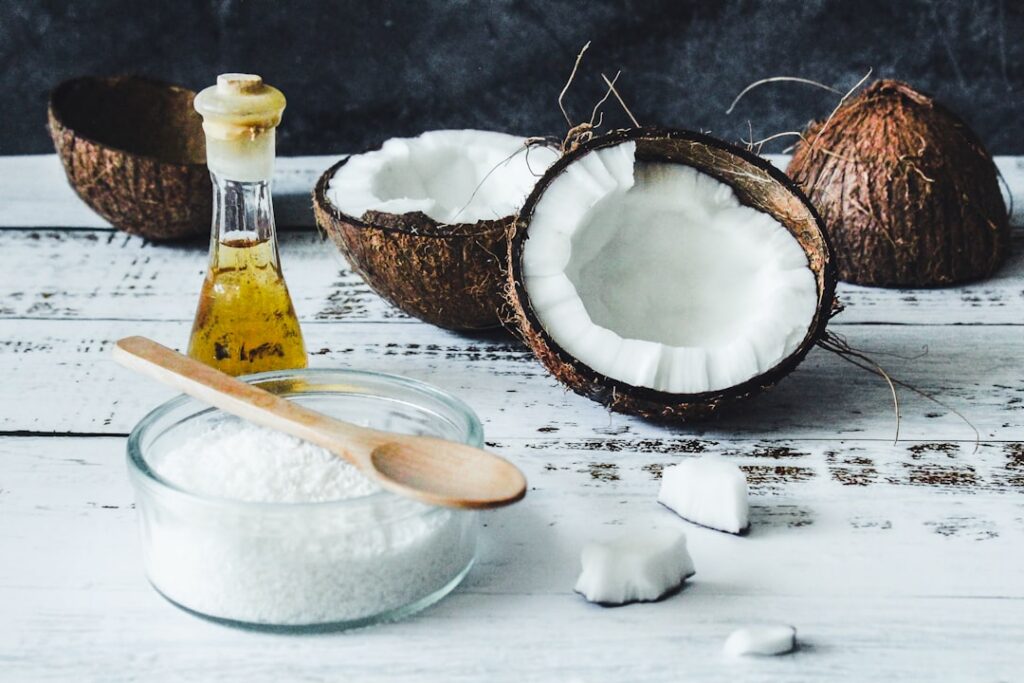 Woman gently massaging an onion and coconut oil mixture into her scalp and hair with her fingertips