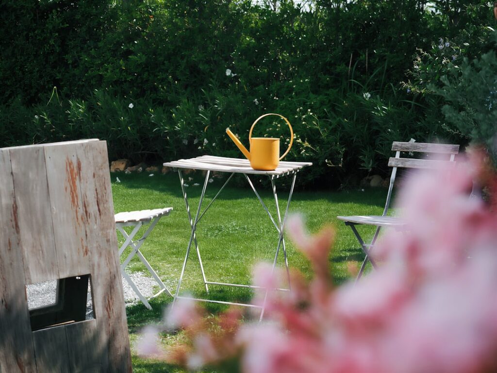 Several small glasses filled with a pale yellow-green liquid garnished with a blade of the plant arranged on a dark slat