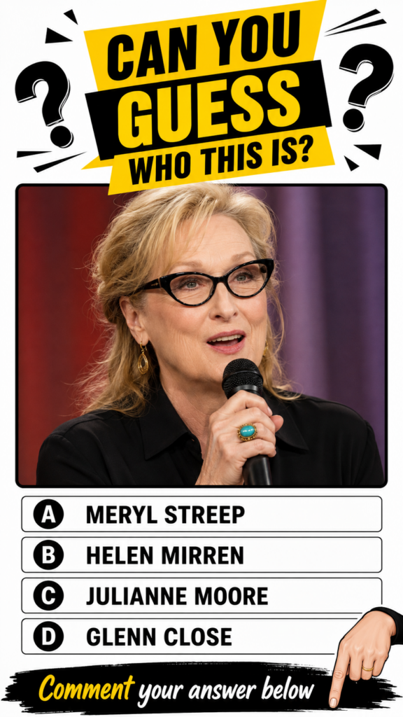 Meryl Streep speaking into a microphone wearing black cat-eye glasses gold hoop earrings and a turquoise ring against a 