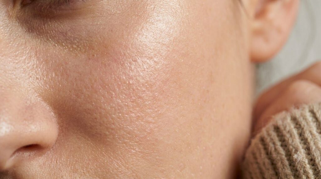 A close-up of healthy glowing skin on a woman s face after applying a beauty product showing a subtle radiance and hydra