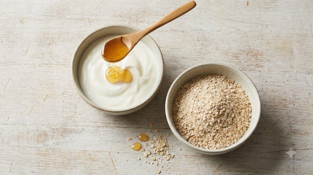 Ingredients for a soothing DIY hydrating face mask a bowl of plain yogurt a spoon with honey and a small bowl of finely 