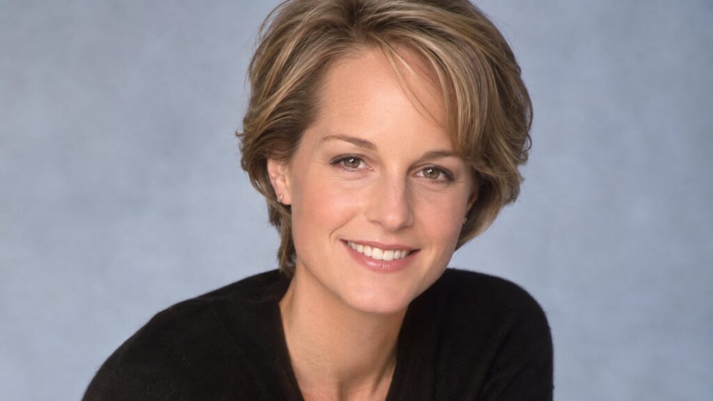 A headshot of a smiling Helen Hunt likely from the late 90s or early 2000s with her signature short light brown hair