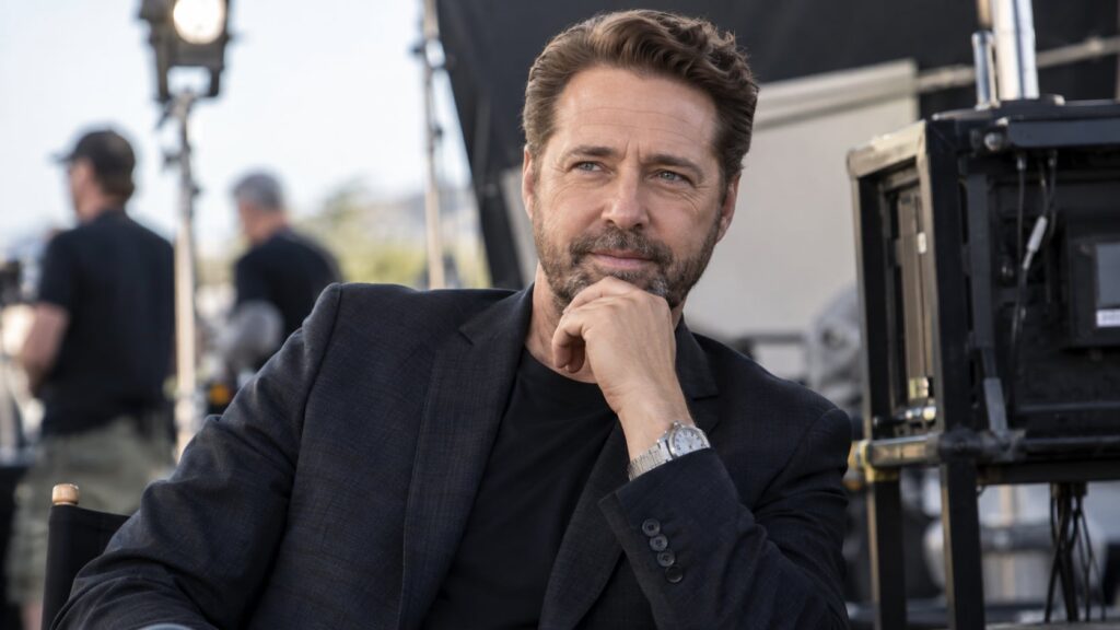 Jason Priestley as an adult looking sophisticated and confident perhaps in a later role or behind the scenes as a direct