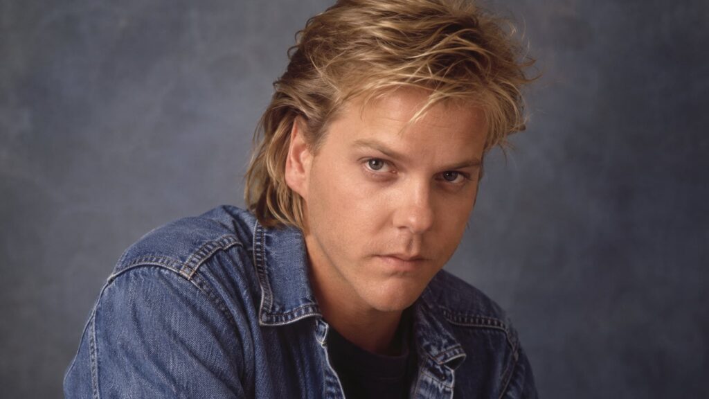 A young Kiefer Sutherland in the 1980s looking intense and serious perhaps from one of his early film roles like The Los
