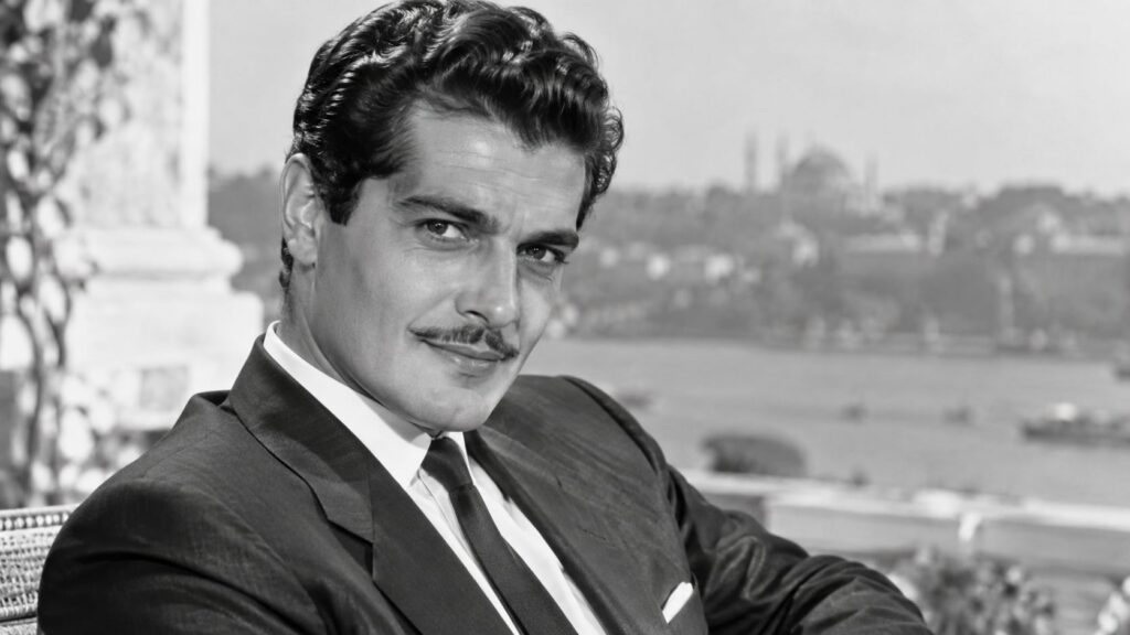 Real archival publicity photo of Omar Sharif looking elegant and sophisticated