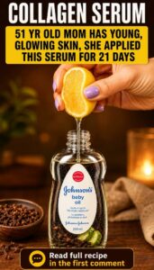 A glass dropper bottle filled with a golden homemade anti-aging serum surrounded by fresh lemons and whole cloves on a c