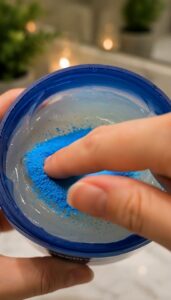 Ingredients for a DIY collagen night gel featuring a small bowl of blue powder a jar of aloe vera gel and a small mixing