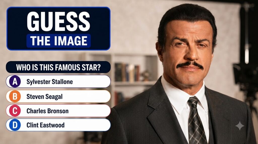 A close-up of a man s lower face with a prominent mustache and upper chest in a suit and tie presented as a quiz questio