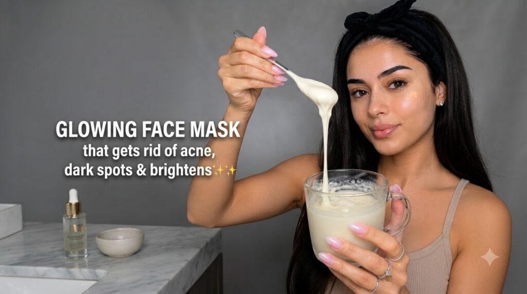 A woman holding a spoon with a creamy face mask dripping into a clear glass mug showcasing clear radiant skin She wears 
