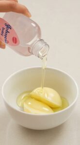 A close-up shot of a clear homemade gel in a small glass jar with aloe vera leaves and a vitamin E capsule blurred in th