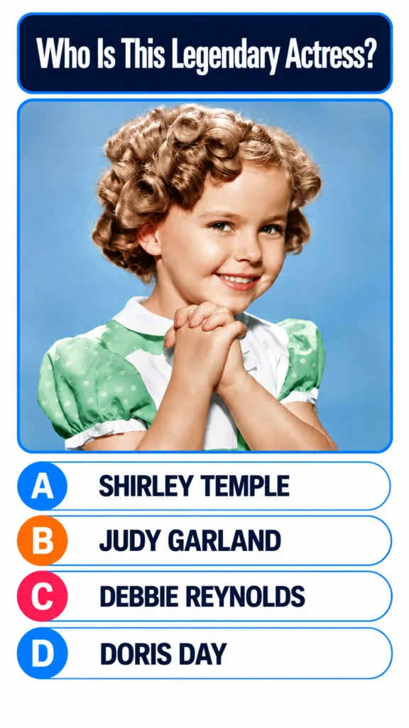 Shirley Temple smiling with curly hair in a green and white dress