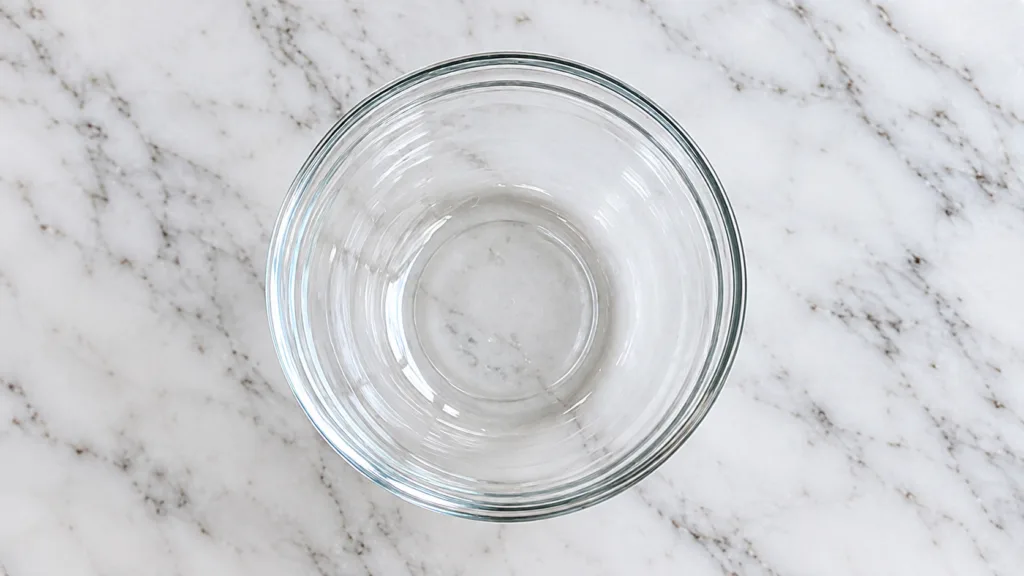 A person mixing ingredients petroleum jelly lemon honey in a small bowl to create a homemade face mask with a bright cle