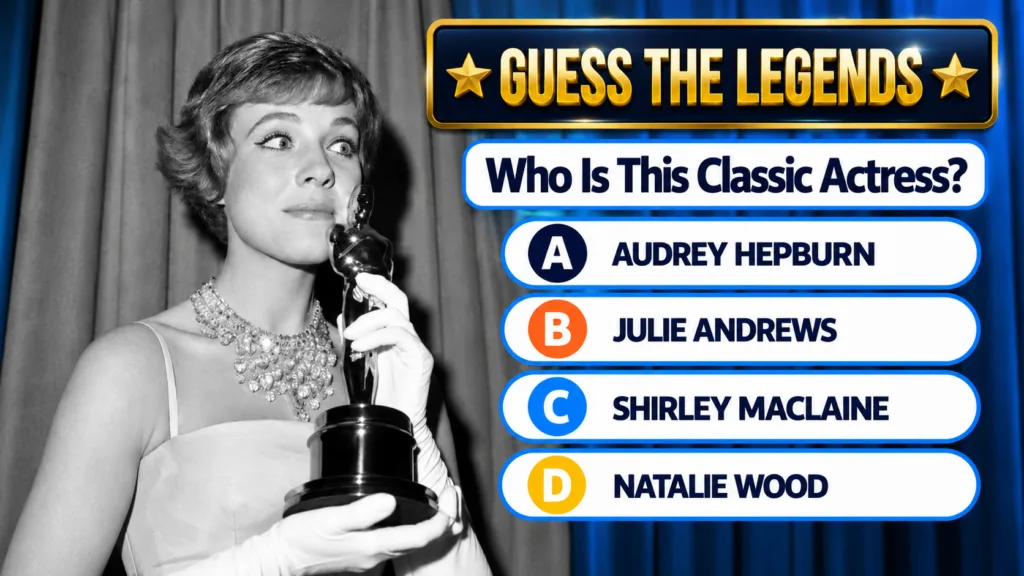Julie Andrews holding her Oscar statuette smiling broadly in a vintage black and white photo