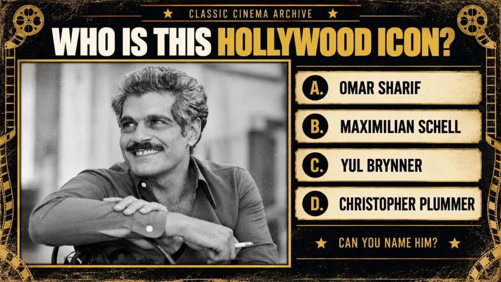 Black and white portrait of Omar Sharif smiling with curly hair and a mustache crossing his arms and looking up It s fra