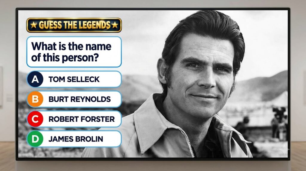 Black and white portrait of a young smiling James Brolin from the chest up with a collared jacket in a quiz game interfa