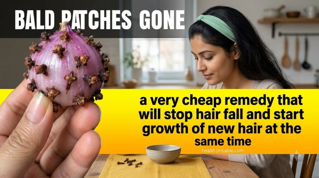 A hand holding a peeled purple onion with dried cloves inserted into it on a rustic wooden background illustrating the m