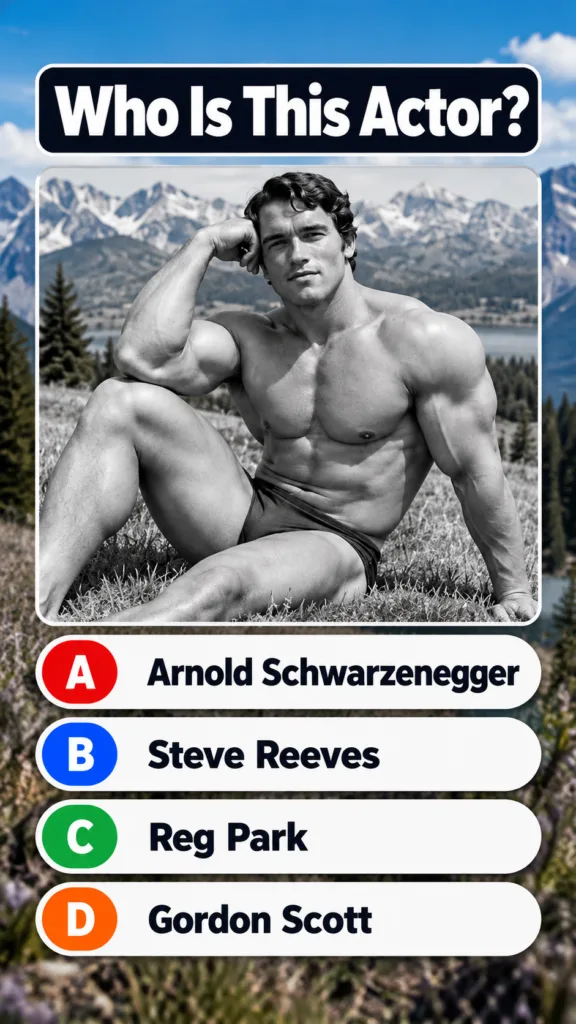 Black and white portrait of a young muscular Arnold Schwarzenegger seated on grass looking directly at the viewer In the
