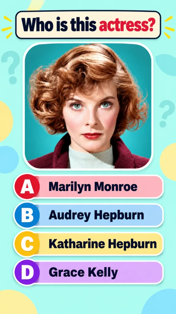 A classic studio portrait of a young Katharine Hepburn with reddish-brown curly hair striking blue-green eyes wearing a 