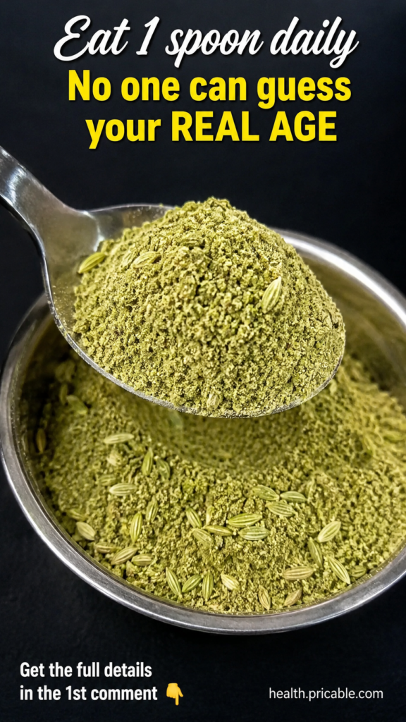 A close-up of a small spoon holding a light-colored beauty powder blend ready to be added to a drink