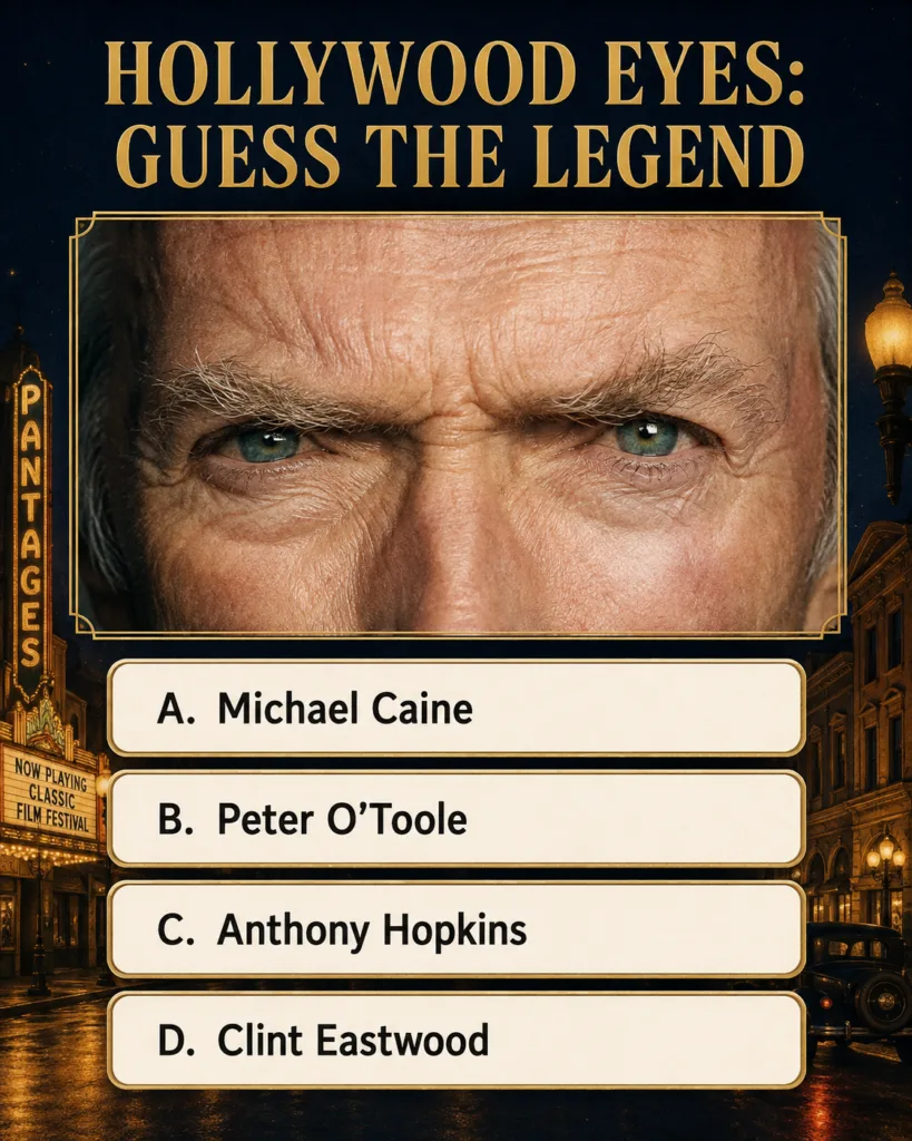 A close-up of a man s intense eyes partially obscured indicating a classic Hollywood actor The eyes are light-colored an