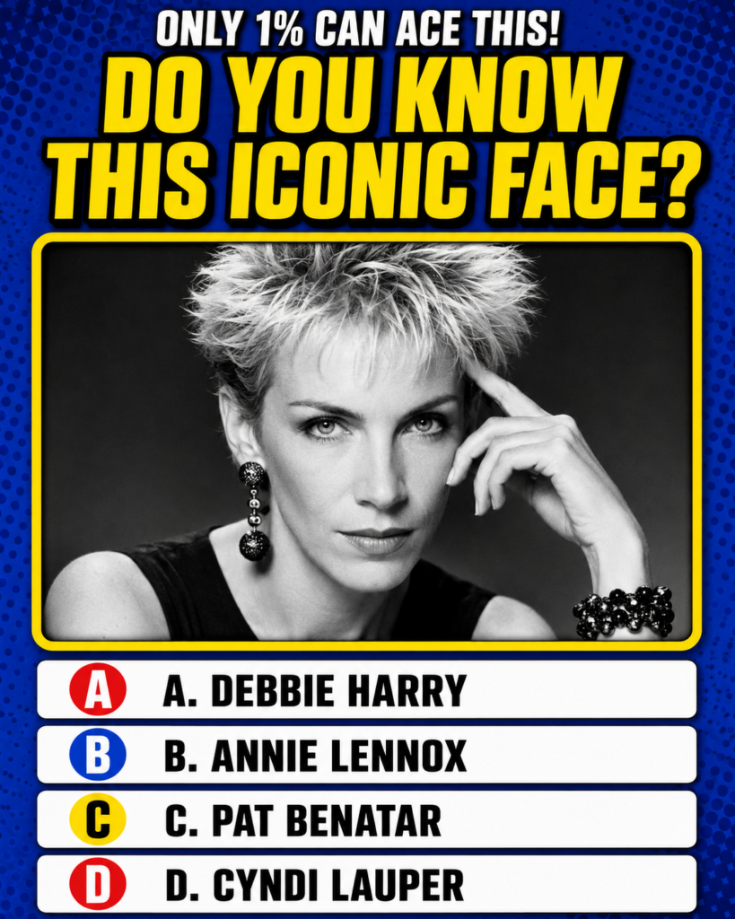 A black and white portrait of Annie Lennox with short spiky hair wearing a prominent dangling earring and a beaded brace