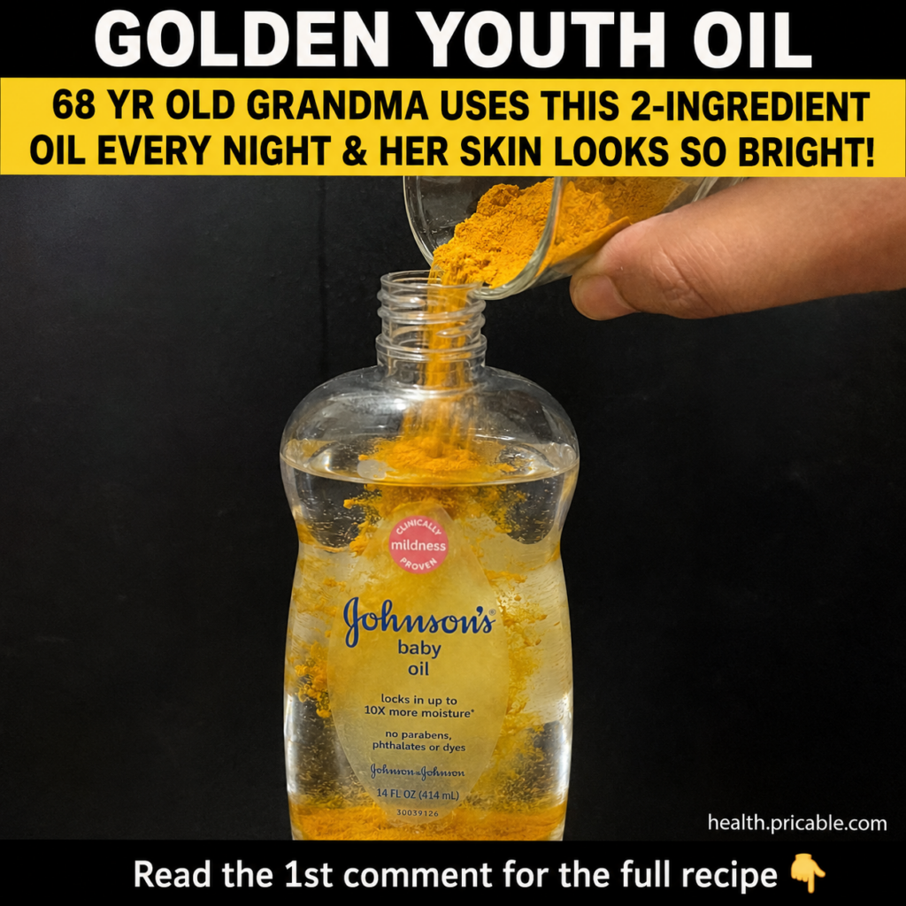 A small glass bowl with golden turmeric powder and a bottle of baby oil next to it set on a rustic wooden surface with s