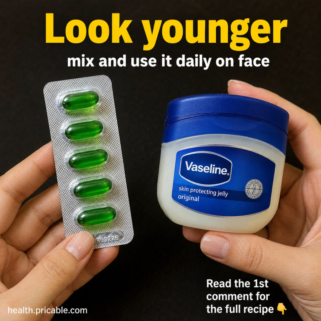 A green beauty oil capsule like a Vitamin E capsule next to an open jar of petroleum jelly Vaseline on a clean light sur
