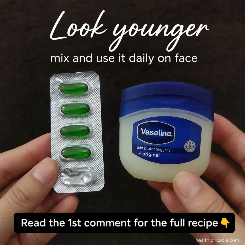 A small jar of Vaseline next to a few Vitamin E capsules on a clean bright bathroom counter suggesting a simple DIY beau