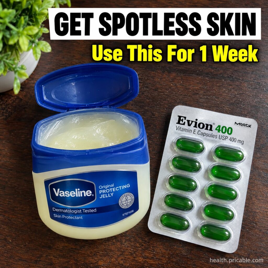A small pot of petroleum jelly Vaseline next to a few Vitamin E capsules on a clean light surface with a hand gently mix
