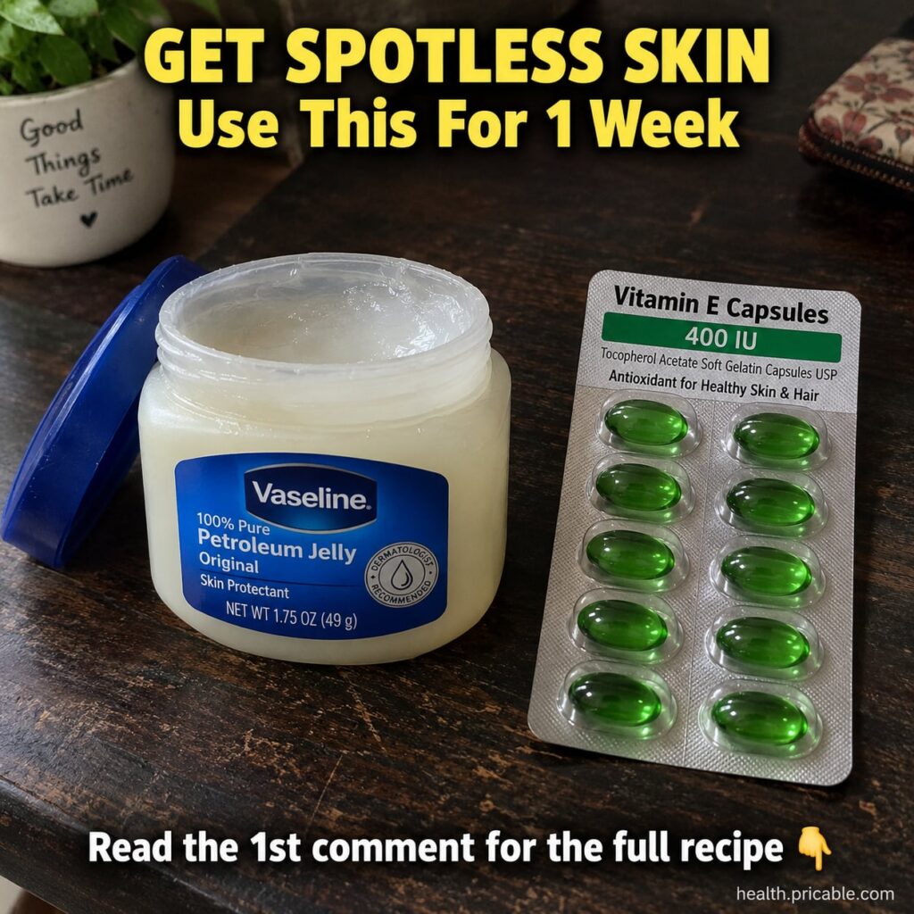 A small clear glass jar filled with a creamy translucent Vaseline and Vitamin E mix placed on a clean white surface with