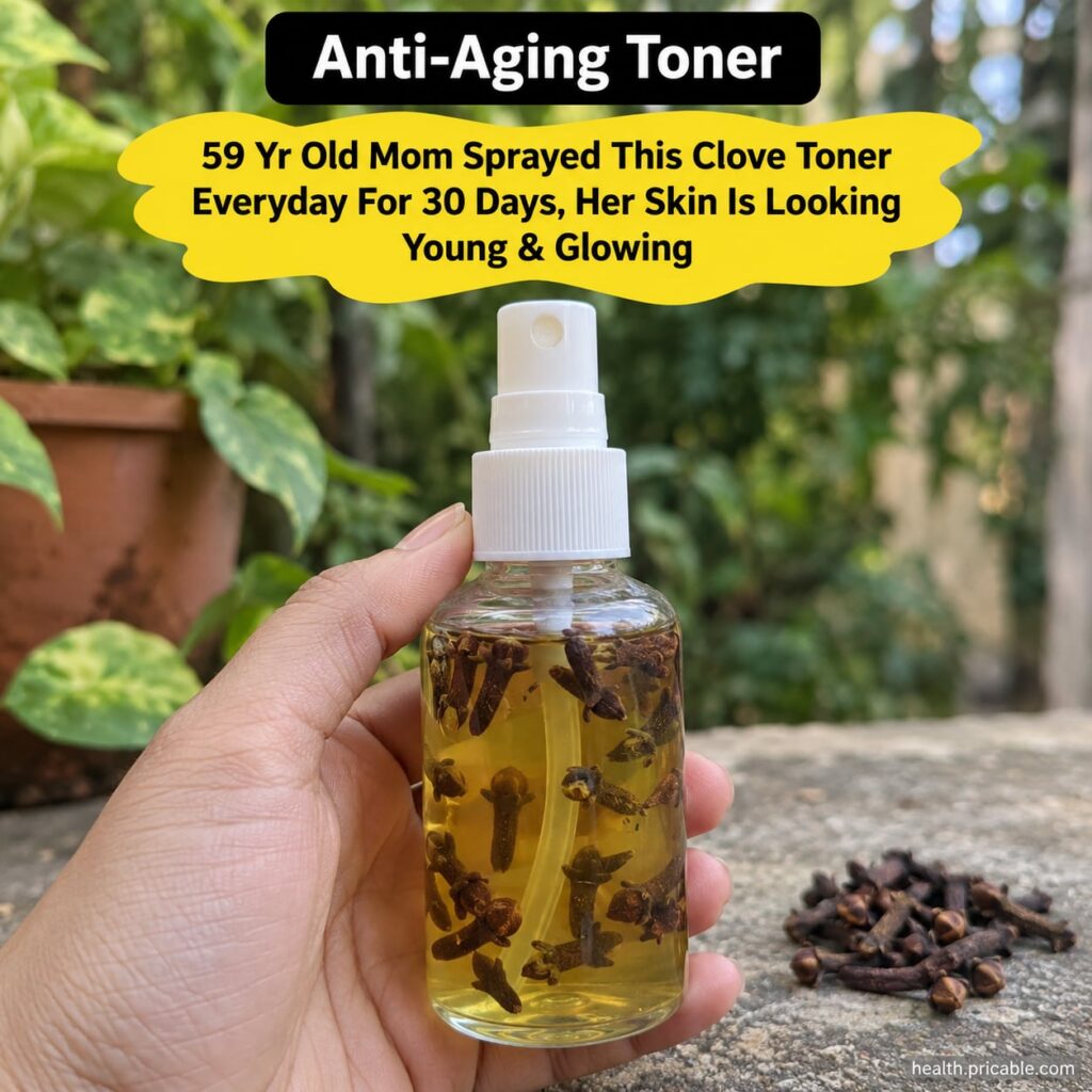 A glass bottle of homemade clove toner with whole cloves scattered around it suggesting a natural and homemade beauty re