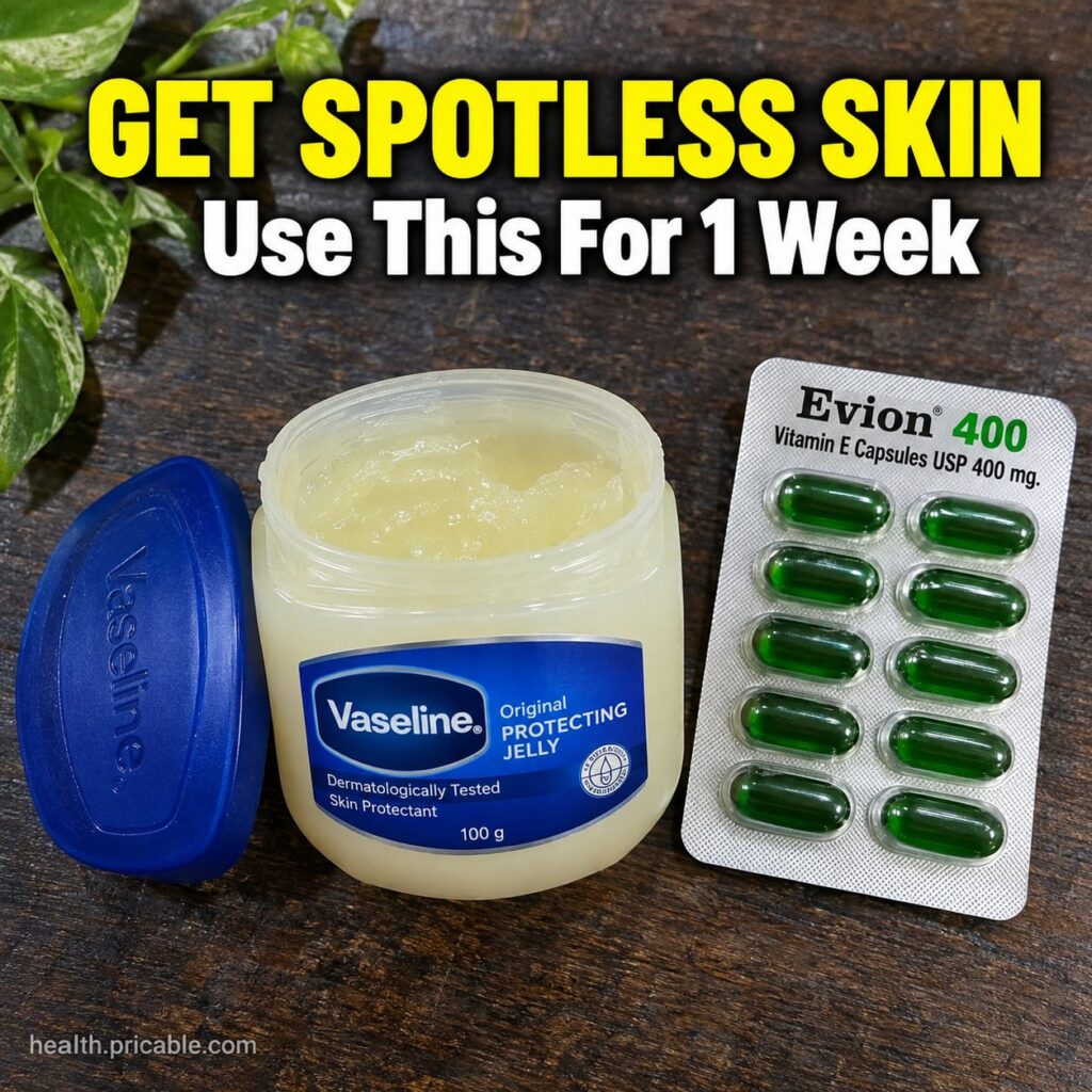 A close-up of a small jar of petroleum jelly Vaseline next to Vitamin E capsules with a hand mixing them in a small dish