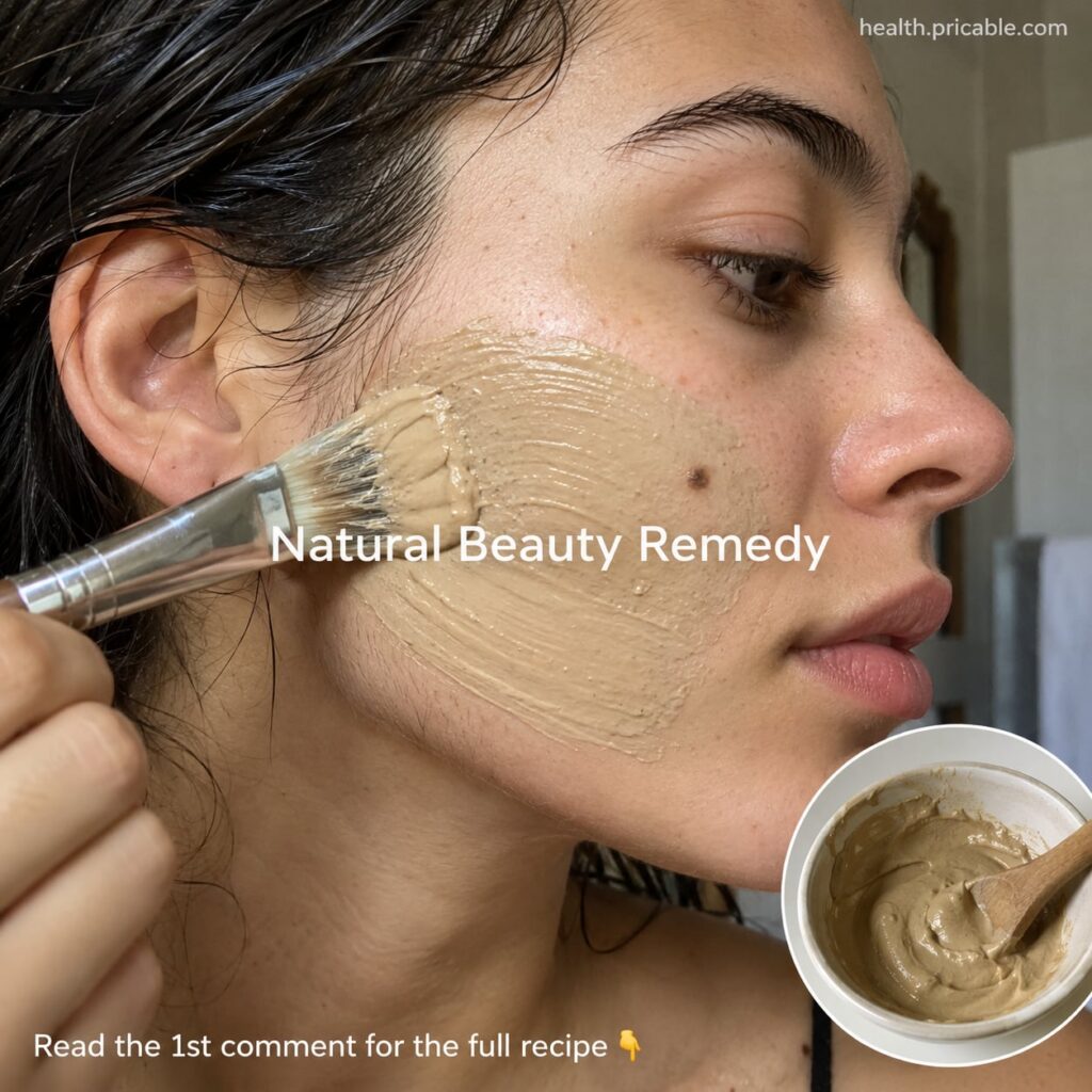 A woman applying a yellow paste mask to her face focusing on areas with fine facial hair with a bowl of the mask mixture