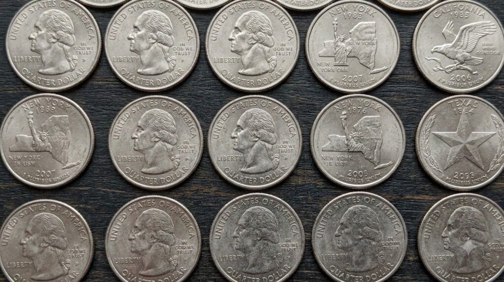 A collection of various U S quarters from the 50 State Quarters Program showcasing different designs from various states