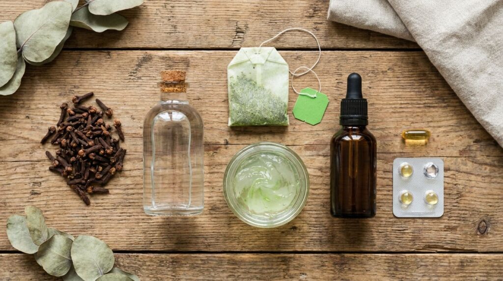 A flat lay of the ingredients for the Clove Wrinkle Eraser Serum whole cloves a bottle of rose water a green tea bag a j