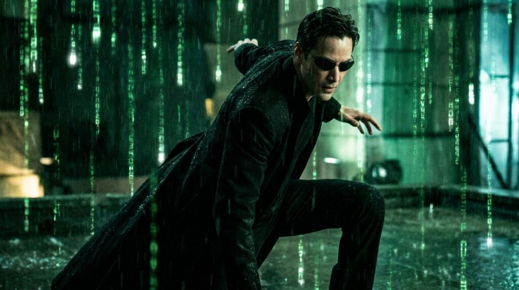 A real movie still from The Matrix showing Keanu Reeves as Neo mid-action or in a recognizable pose demonstrating his ic