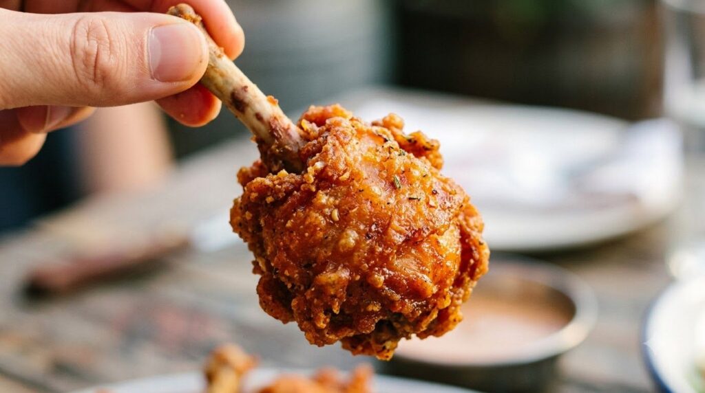 Close-up of a chicken lollipop with a perfectly crispy golden-brown skin highlighting its texture