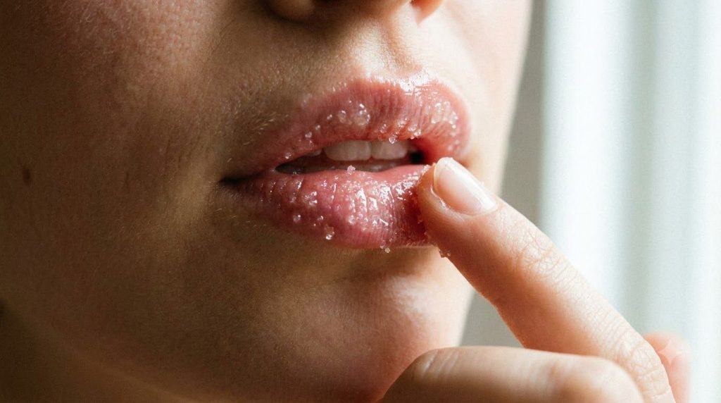 A close-up of a woman s lips with the Gentle Sugar Lip Face Smoother applied showing a subtle sheen and texture
