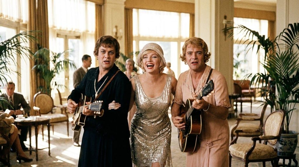 A still image from the movie Some Like It Hot featuring Marilyn Monroe Jack Lemmon and Tony Curtis in a comedic scene