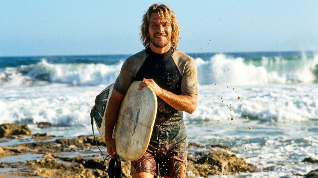 Patrick Swayze as Bodhi in Point Break possibly surfing or looking intense