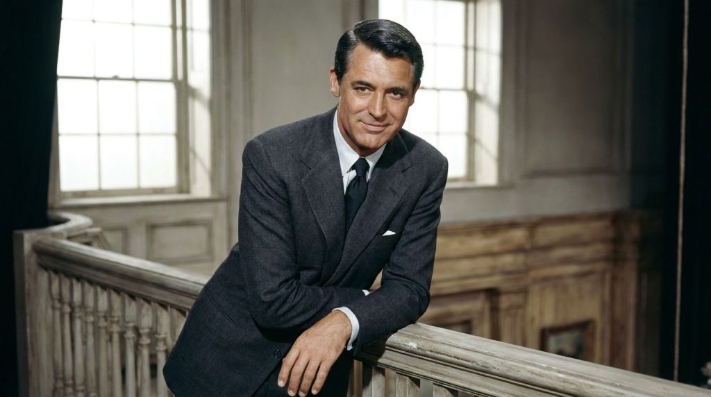 Cary Grant in a still from one of his classic romantic comedies looking charming and elegant