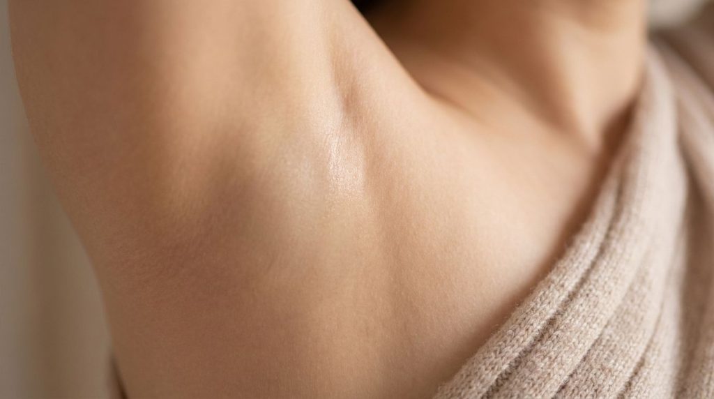 A close-up of a smooth healthy-looking underarm subtly implying results after gentle care with no visible irritation