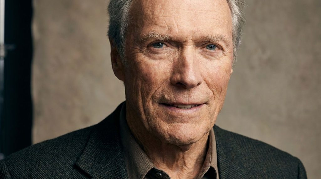 A recent distinguished portrait of an older Clint Eastwood perhaps for a film premiere or publicity shot showing his ico