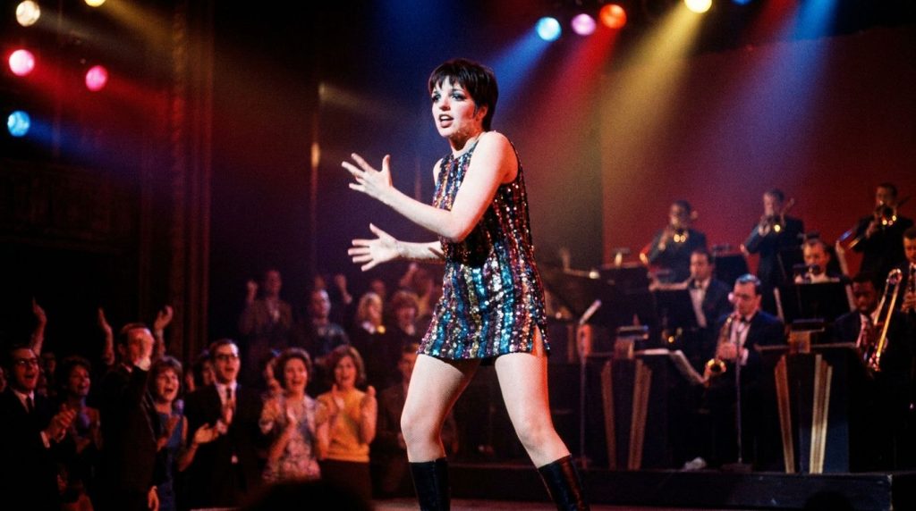 Liza Minnelli performing on a Broadway stage in her early career perhaps during Flora the Red Menace dressed in a theatr