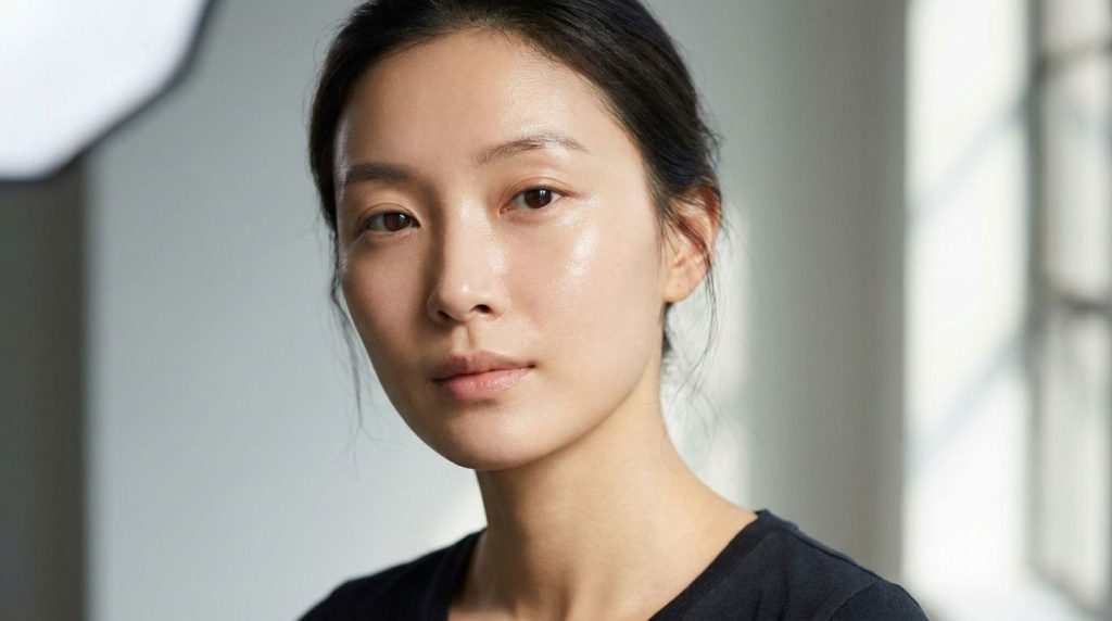 Close-up of a woman s face with visibly smooth glowing glass skin showcasing the result of the skincare routine